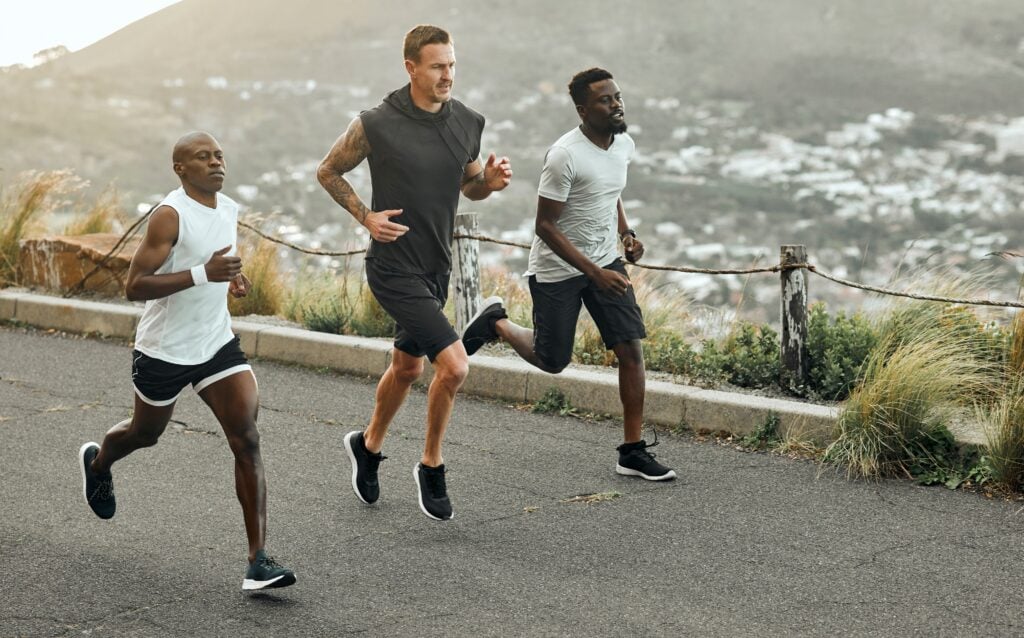 3 guys running on the road, in shape
