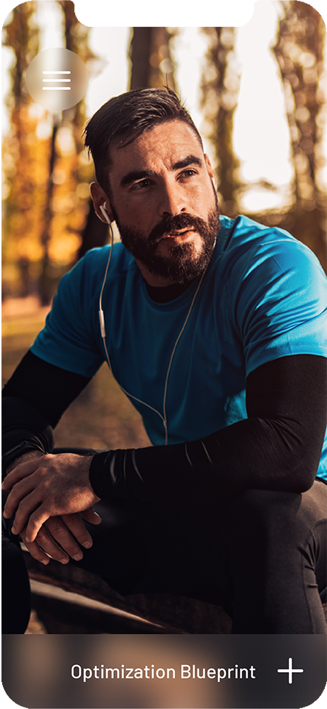 Iphone background of man in woods sitting on a table with headphones in, arms rested on knees