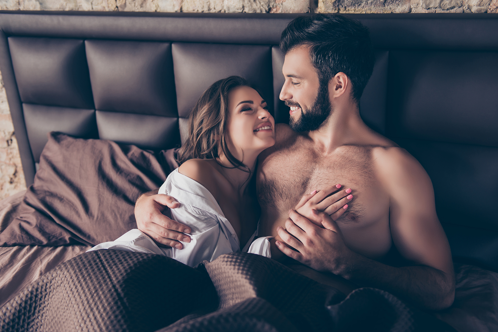 man-woman-bed-smiling
